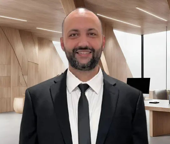 Man in suit standing in modern office | Sleepy Baby